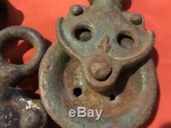 Four Antique Metal Pulleys